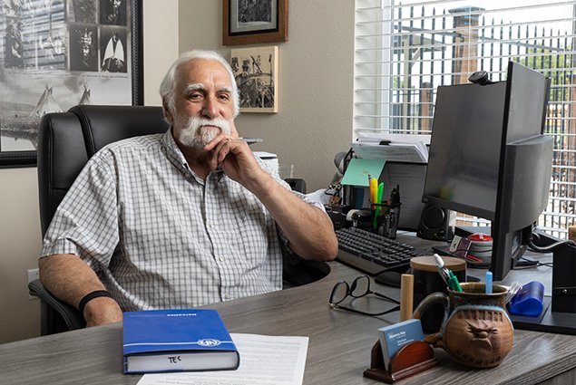 Richard Brown behind his desk at Marvel Way Apartments in Reno, NV