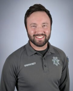 Sergeant Andrew Sherbondy headshot in dark grey polo shirt