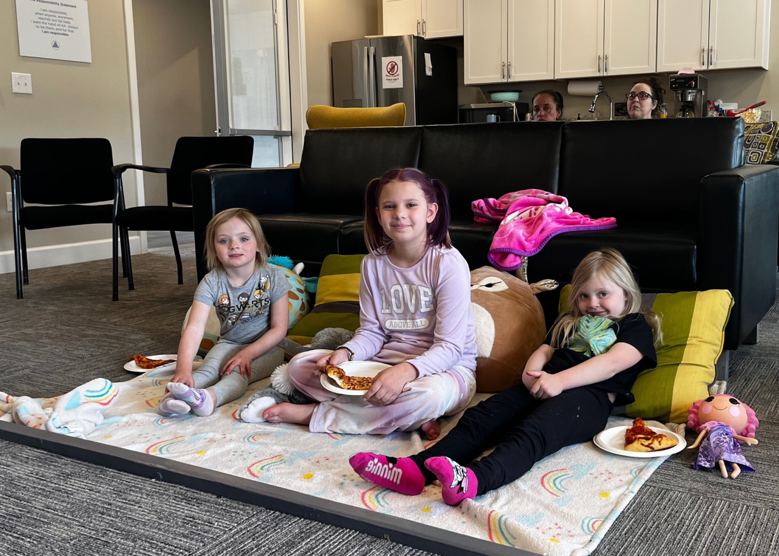 3 children at movie night at the marvel way sober living apartments