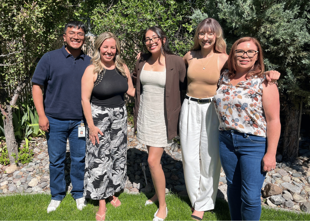 the empowerment center's 5 2024 summer interns posing together in our treatment center's green backyard