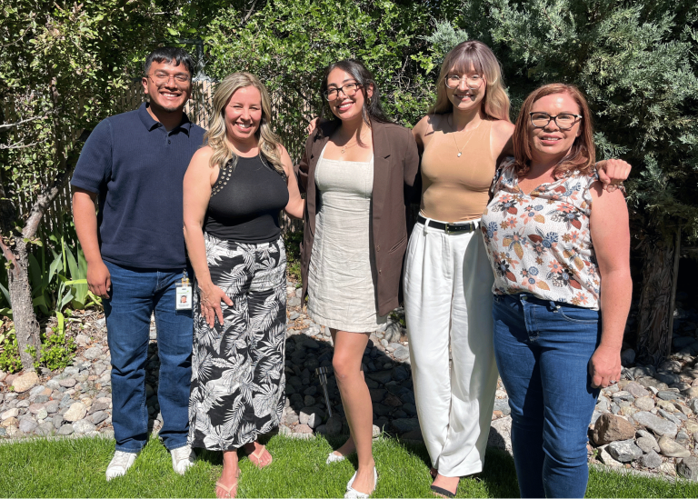 the empowerment center's 5 2024 summer interns posing together in our treatment center's green backyard
