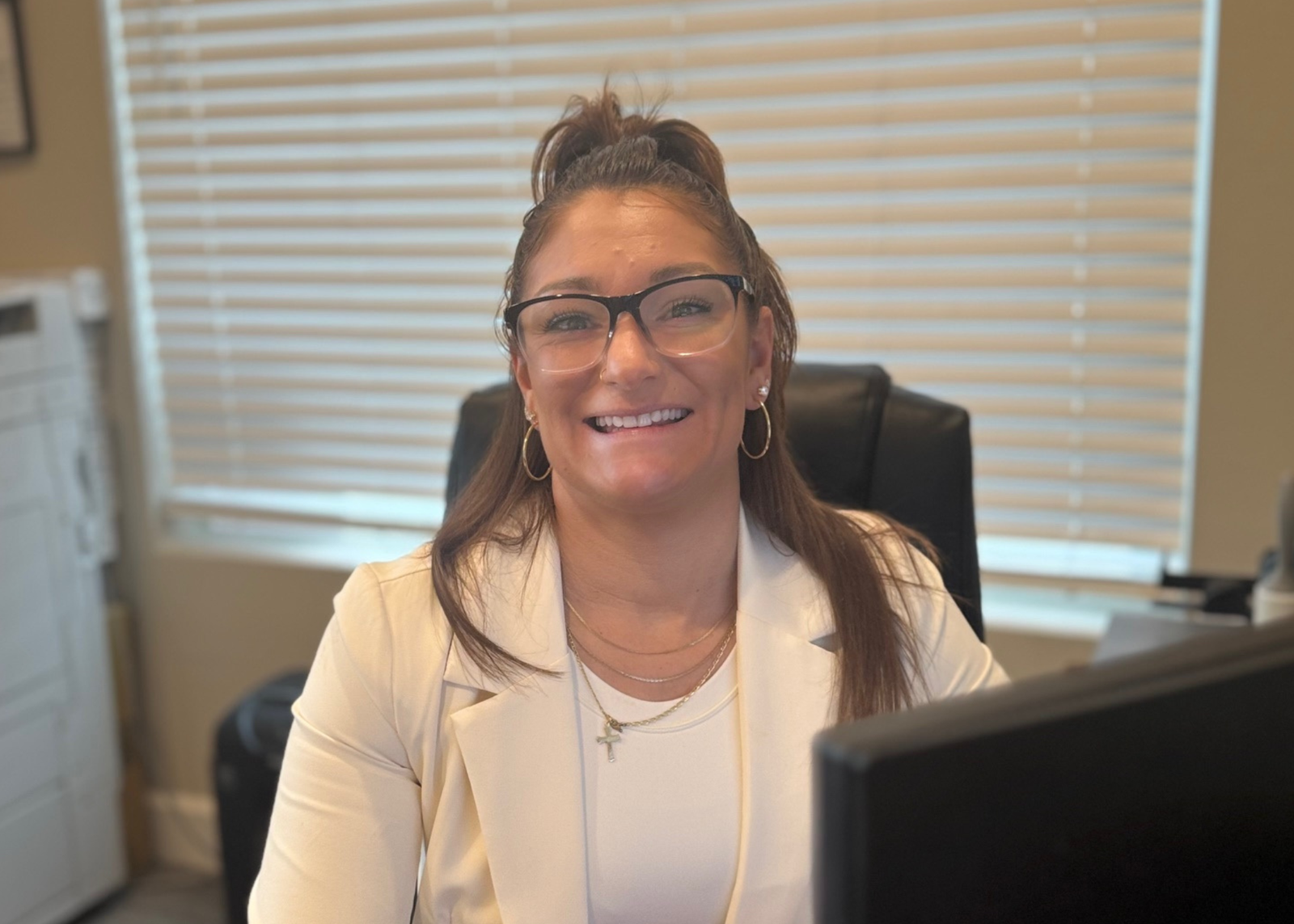 rikki reedle sitting at her computer in her marvel way reno office